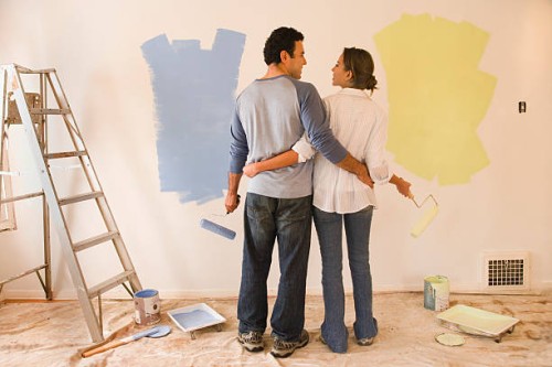couple painting room, rear view - home decoration stock pictures, royalty-free photos & images