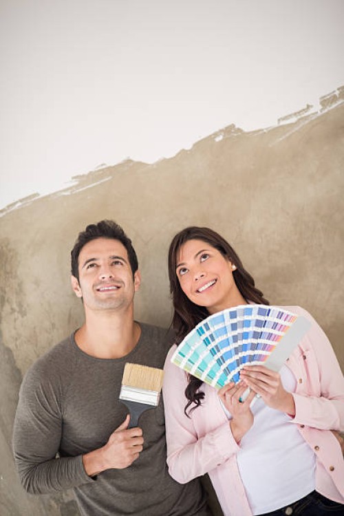 couple painting their house together - home decoration stock pictures, royalty-free photos & images