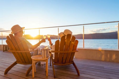 couple relaxing and drinking wine and toasting on deck chairs - travel stock pictures, royalty-free photos & images