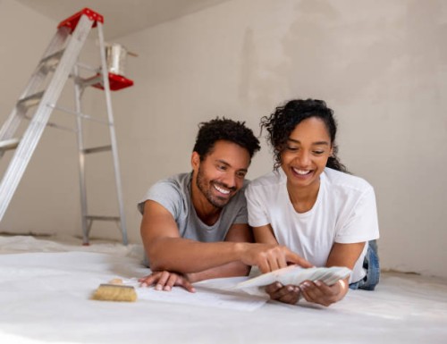 couple remodeling their house and choosing a color for the walls using a palette - home decoration stock pictures, royalty-free photos & images