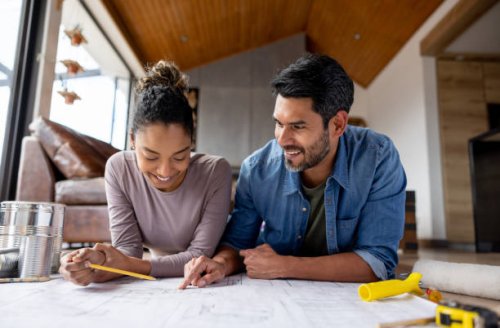 couple remodeling their house and looking at blueprints - home decoration stock pictures, royalty-free photos & images