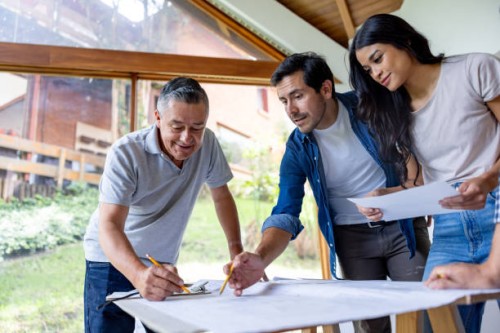 couple remodeling their house and taking to the architect while looking at blueprints - home decoration stock pictures, royalty-free photos & images