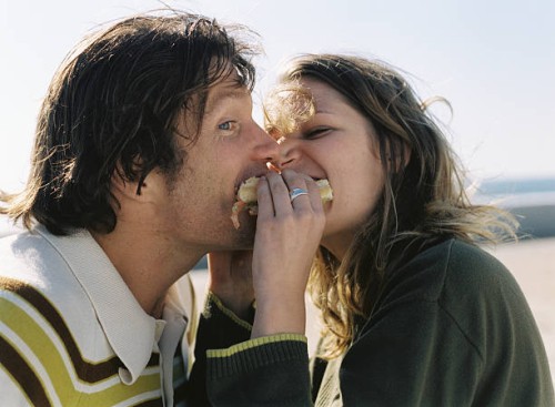 couple sharing sandwich - food stock pictures, royalty-free photos & images