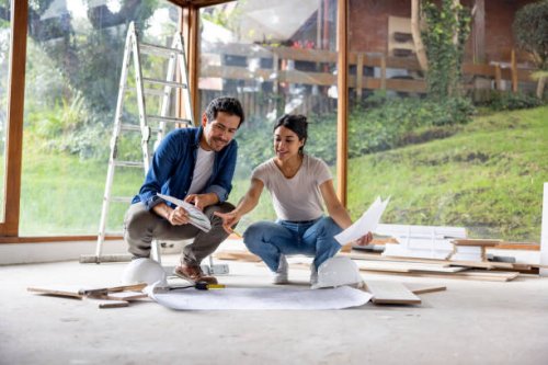 couple sharing some decoration ideas while renovating their house - home decoration stock pictures, royalty-free photos & images