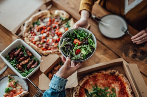 couple sharing takeaway meal at home - junk food stock pictures, royalty-free photos & images