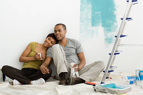 couple taking a break from painting - home decoration stock pictures, royalty-free photos & images