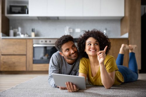 couple thinking about the decoration of their house using an app on a tablet - home decoration stock pictures, royalty-free photos & images
