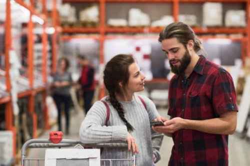 couple using smart phone in hardware store - home decoration stock pictures, royalty-free photos & images