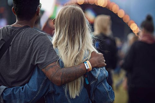 couple with arms around each other at concert - concert stock pictures, royalty-free photos & images