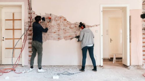 couple working on reconstruction of their apartment - home decoration stock pictures, royalty-free photos & images