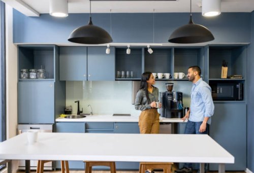 coworkers talking in the cafeteria while taking a break at the office - coffee stock pictures, royalty-free photos & images