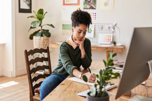 creative business woman planning on paper, designer writing on blueprint and thinking of ideas for fashion clothing in a modern work office. business owner or stylist working on drawing of clothes - fashion stock pictures, ro