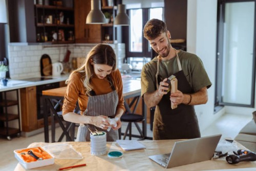 creative young couple watching online tutorial about woodcraft - home decoration stock pictures, royalty-free photos & images