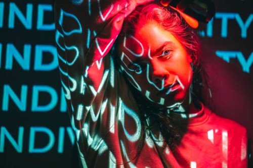 crimson red technological concept with a person lit with neon cyan projection - fashion stock pictures, royalty-free photos & images