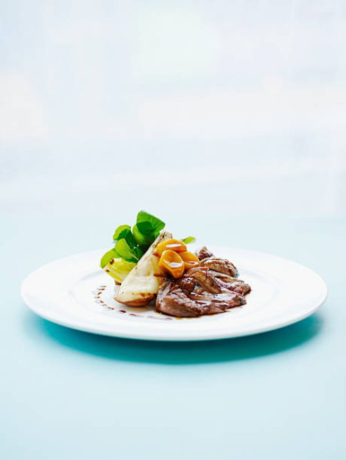 crisp liberty duck breast, braised endive, watercress and grilled pears. - food stock pictures, royalty-free photos & images