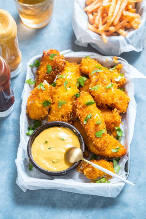 crispy baked cod fish nuggets with crisps on side. - junk food stock pictures, royalty-free photos & images