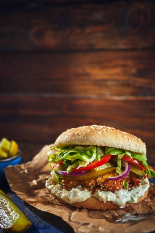 crispy chicken burger with cheese, tomato, onions and green salad - junk food stock pictures, royalty-free photos & images