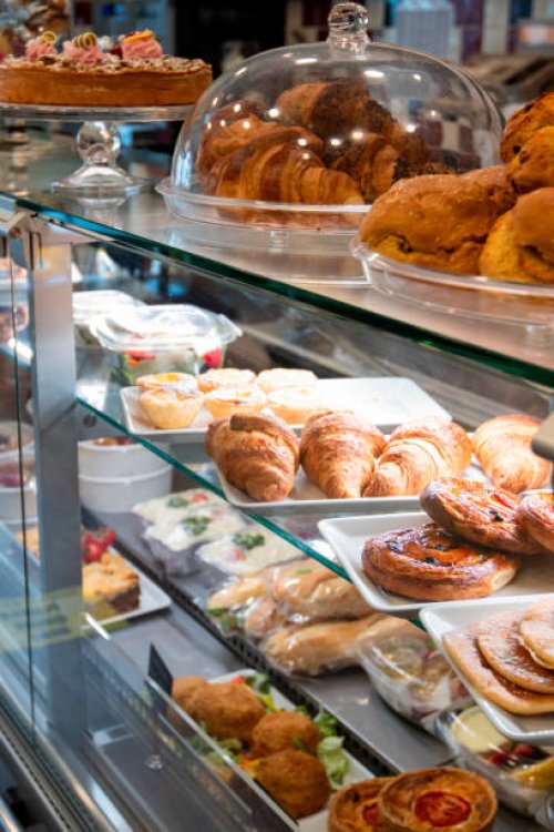 croissants, sandwiches and other pastries displayed in bakery for take away - junk food stock pictures, royalty-free photos & images