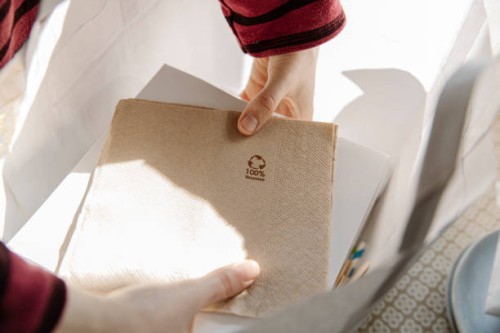 crop person putting takeaway food out of paper bag - junk food stock pictures, royalty-free photos & images