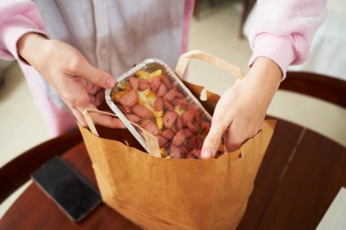 crop woman unpacking takeaway junk food - junk food stock pictures, royalty-free photos & images