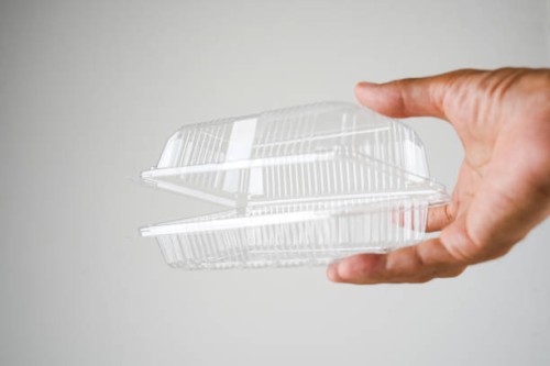 cropped hand holding plastic food container - junk food stock pictures, royalty-free photos & images