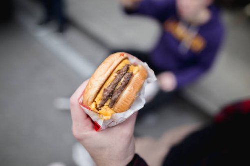 cropped hand of person holding burger,san francisco,california,united states,usa - junk food stock pictures, royalty-free photos & images