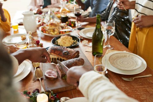 cropped hands of man cutting meat on dining table - food stock pictures, royalty-free photos & images