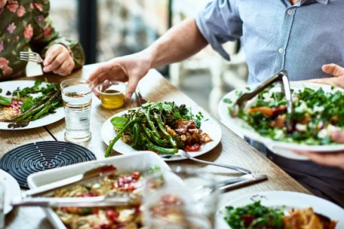 cropped view of table laid with crockery and fresh homemade vegetarian food - food stock pictures, royalty-free photos & images