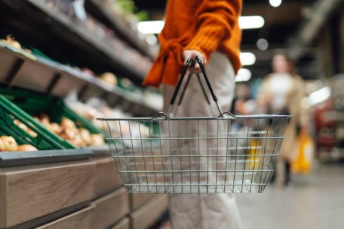 cropper shot of young woman carrying a shopping basket while shopping in supermarket - food stock pictures, royalty-free photos & images