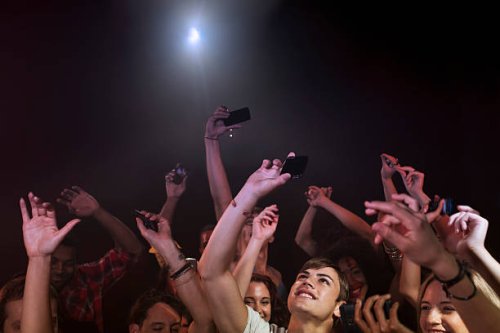 crowd in nightclub holding up cell phones - concert stock pictures, royalty-free photos & images