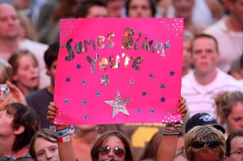 Crowd member holds a banner during the Live Earth concert at Wembley Stadium on July 7, 2007 in London, England. Live Earth is a 24-hour, 7-continent...