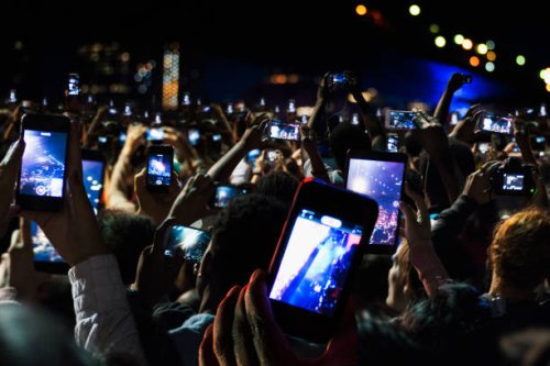 crowd of people recording video with cell phones at night - concert stock pictures, royalty-free photos & images