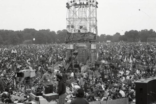 Crowds react as they listen to Paul Simon and Art Garfunkel perform on stage at the Great Lawn in Central Park in Manhattan on September 19, 1981. It...