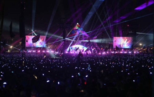 Crowds wear illuminated wristbands as they listen to Coldplay perform on the Pyramid Stage on the fourth day of the Glastonbury festival at Worthy...