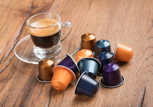 cup of coffee with capsules, nestle nespresso kaffeekapseln - coffee stockfoto's en -beelden