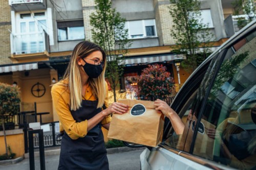 curbside pick up restaurant worker giving order bags to customer - junk food stock pictures, royalty-free photos & images
