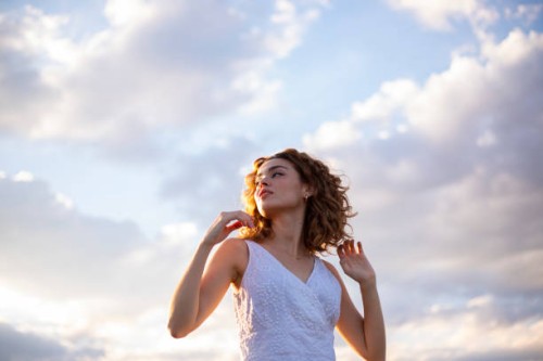 curly hair woman outdoors sky background - fashion stock pictures, royalty-free photos & images