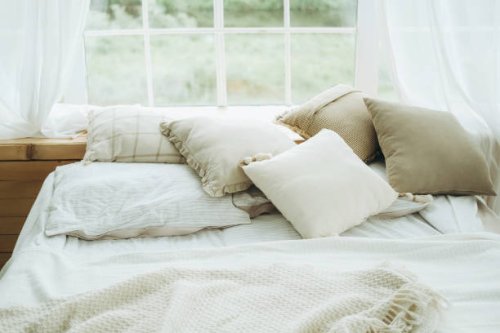 cushions, pillows, blanket and plaid on a bed against a window. - garden decoration stock pictures, royalty-free photos & images