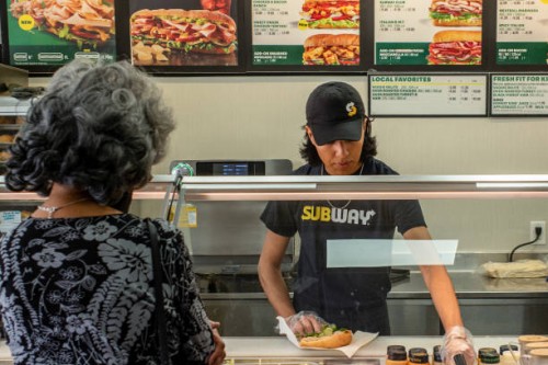 Customer orders food at a Subway fast-food restaurant on April 29, 2022 in Houston, Texas. The fast-food chain closed over 1,000 stores last year and...