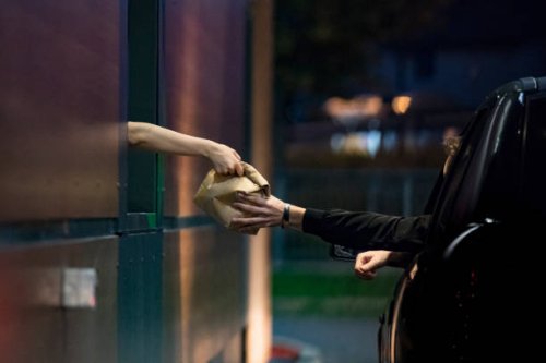 customer receiving food at drive thru - junk food stock pictures, royalty-free photos & images