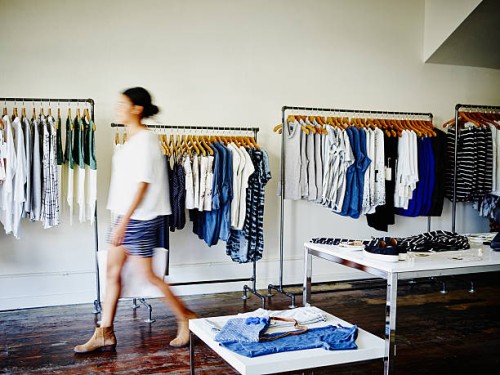 customer with shopping bag walking in boutique - fashion stock pictures, royalty-free photos & images