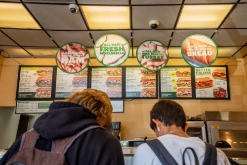 Customers order food at a Subway fast-food restaurant on April 29, 2022 in Houston, Texas. The fast-food chain closed over 1,000 stores last year and...
