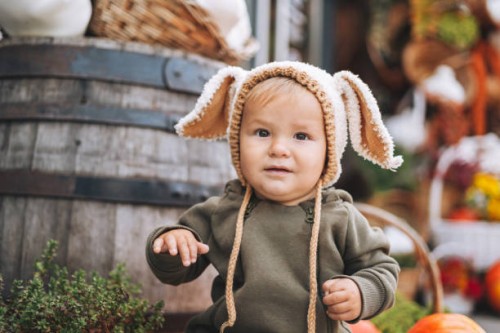 cute baby boy sitting on pumpkin - garden decoration stock pictures, royalty-free photos & images