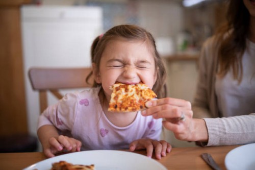 cute girl eating pizza - junk food stock pictures, royalty-free photos & images