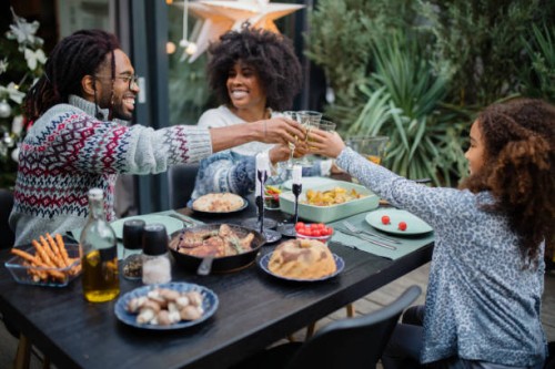 cute girl having dinner with parents - garden decoration stock pictures, royalty-free photos & images
