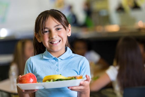 cute hispanic girl in private school cafeteria lunchroom - food stock pictures, royalty-free photos & images