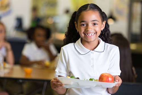cute little girl in school cafeteria with food tray - food stock pictures, royalty-free photos & images
