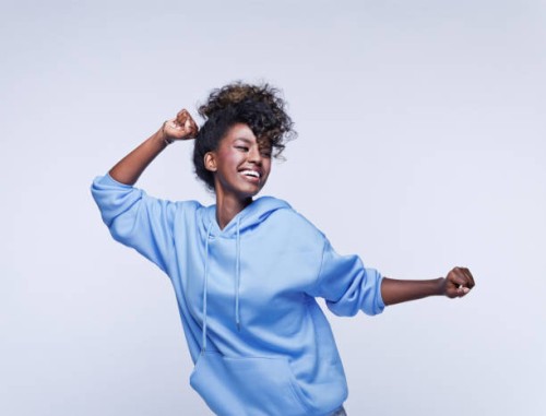 dancing young woman in blue hoodie - fashion stock pictures, royalty-free photos & images