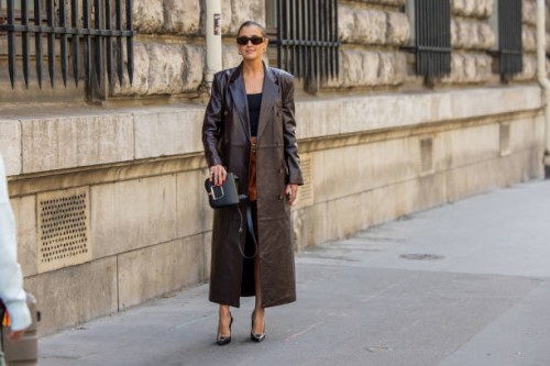 Darja Barannik wears brown leather short, brown shorts, black top, black bag outside Hermes during the Womenswear Spring/Summer 2024 as part of Paris...