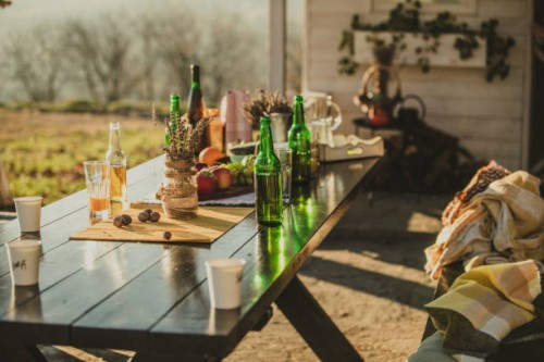 decorated autumn garden table with beer bottles - garden decoration stock pictures, royalty-free photos & images